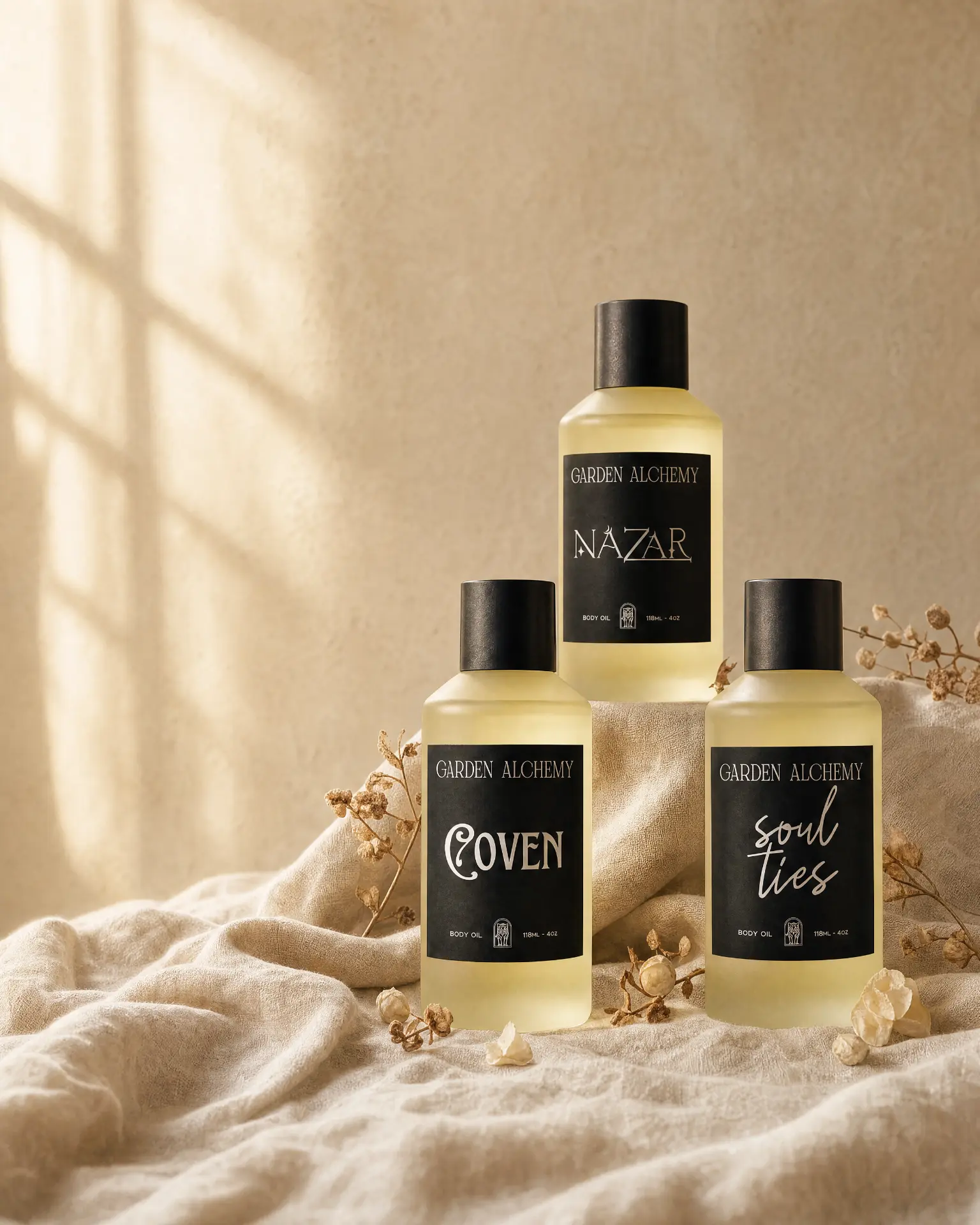 Soul Ties, Nazar, and Coven Garden Alchemy body oils styled on cream fabric